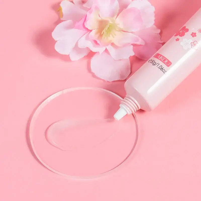 LAIKOU Japan Sakura Eye Cream on pink background with sakura flower and clear gel on a round plate